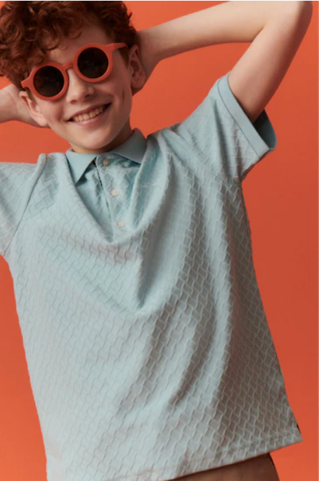 Kid model in mint polo